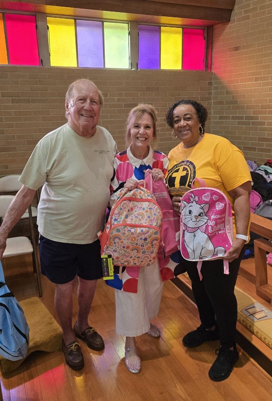 From left, Donald Treich, Pastor Jane McCready and Valerie Norman of First Baptist Church of Kenilworth receive backpacks for local families.