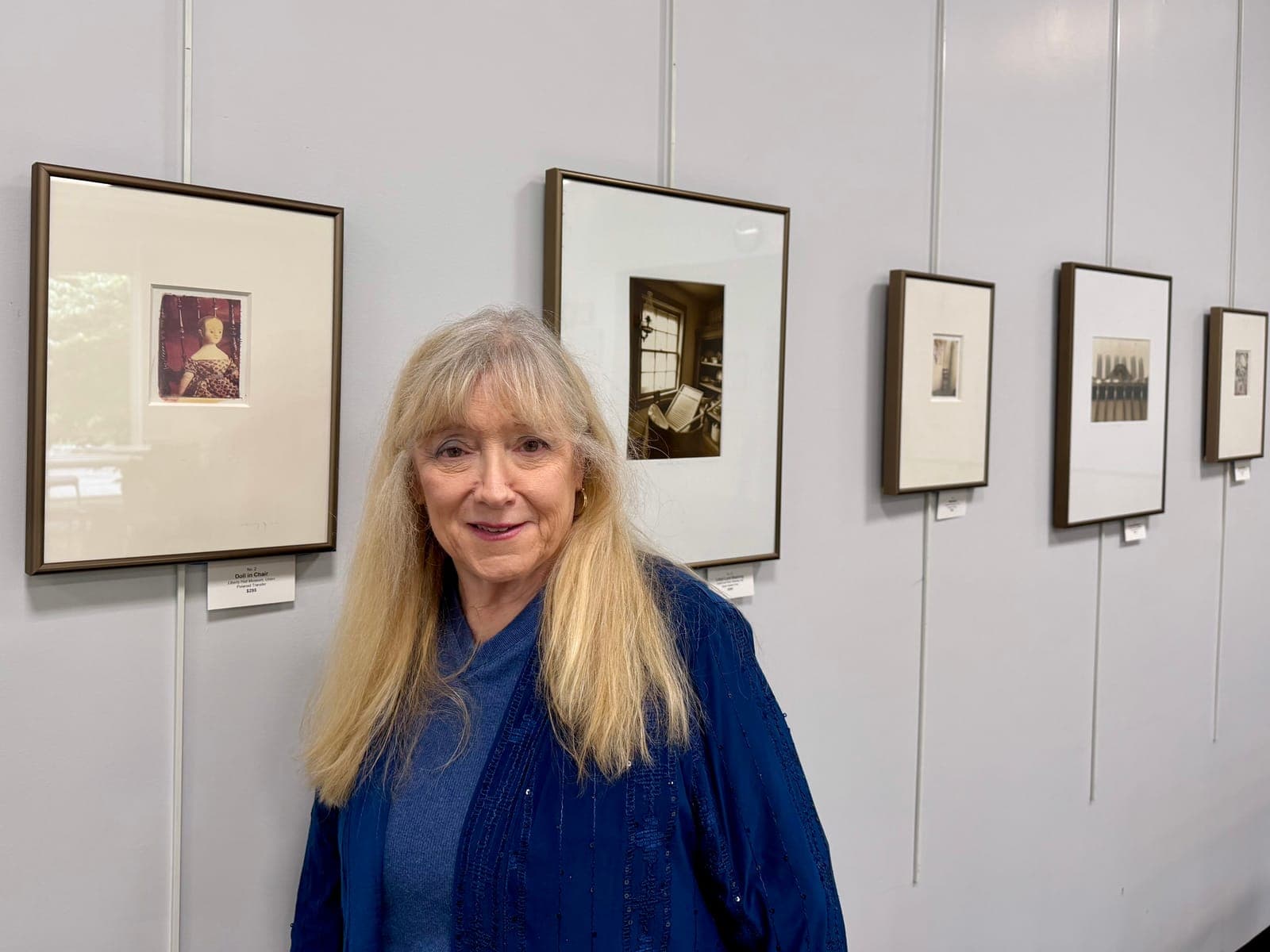 Photographer Nancy J. Ori stands with her Four Centuries Story exhibit in the Conti Family Community Room at New Providence Memorial Library.