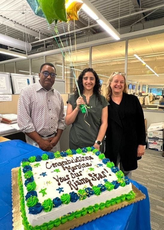 Martina Yakoub, center, is congratulated by colleagues Julien Napoleon and Donna King after being named the recipient of the 2026 J. Marilyn MacQueen Rising Star Award.